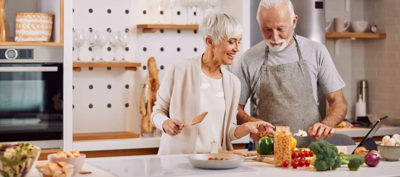 happy and healthy seniors prepare vegan food at home