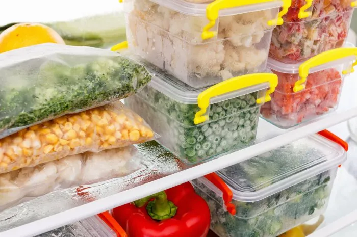 frozen food in the refrigerator vegetables on the freezer shelves stocks of meal for the winter