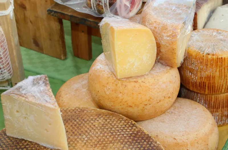 seasoned cheeses made with sheep and cow s milk and goat for sale at the local market