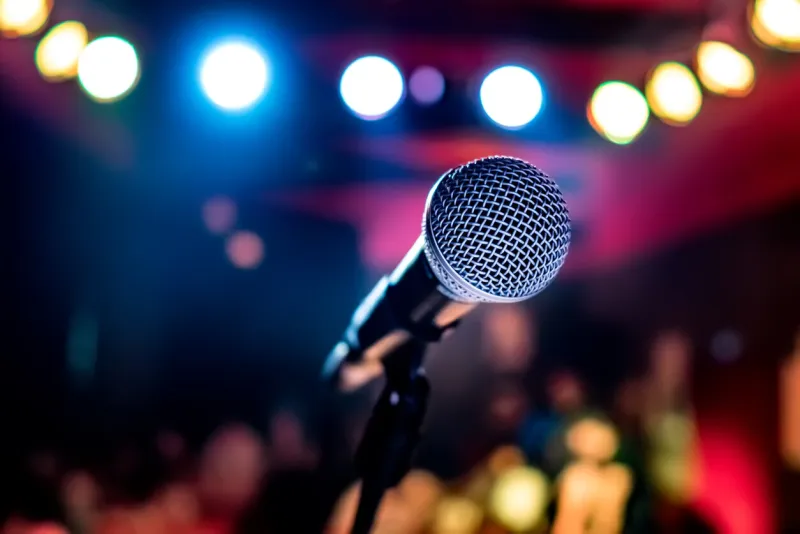public performance on stage microphone on stage against a background of auditorium shallow depth of field public performance on stage
