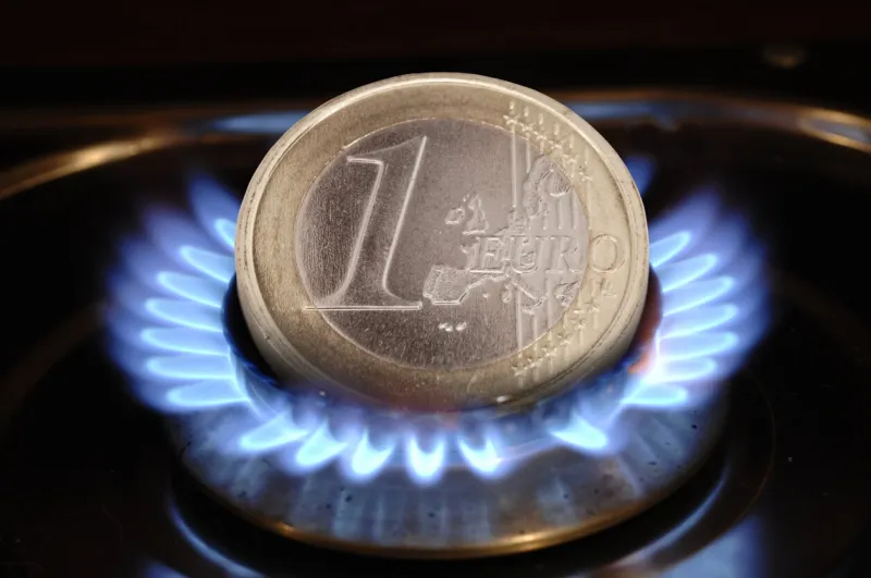 euro coin and gas heating as symbol for expensive energy costs