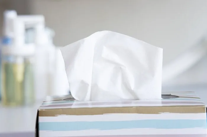 light color napkin tissue box on white background cold and flu concept