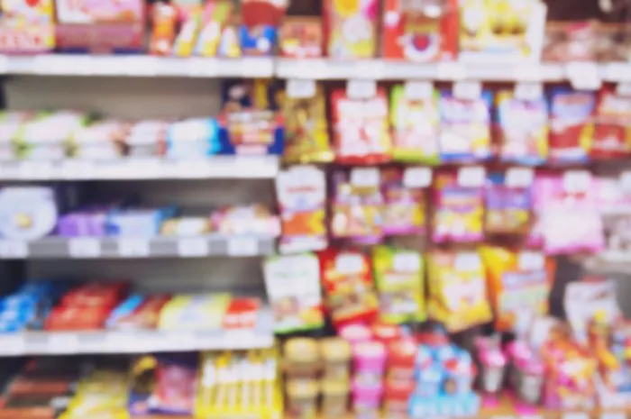 blur photo background of snacks and consumer product colorful in supermarket shop shelf mini-mart shopping convenience stores are a new alternative for the urban people concept