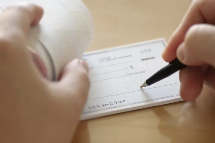 businessman prepare writing check in the office