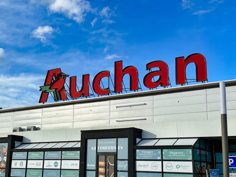 lille, france - april 12 2023  the big auchan sign has been placed on top off a location of the grocery store chain property