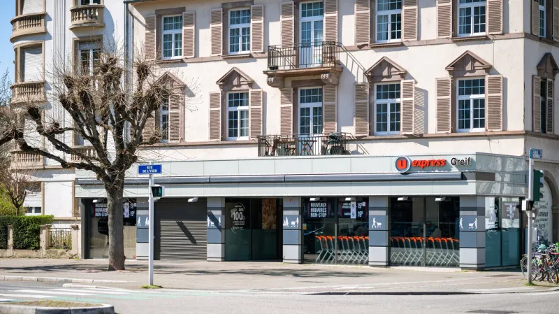 strasbourg, france - mar 22, 2020  empty street with u express grief iconic supermarket during french general confinement during covid-19 coronavirus pandemic situation no people