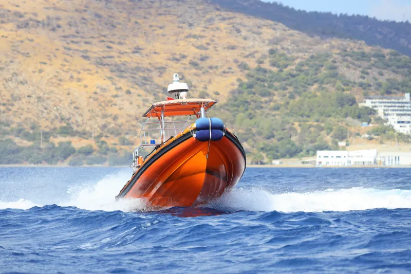 the coast guard boat conducts inspection in the aegean sea