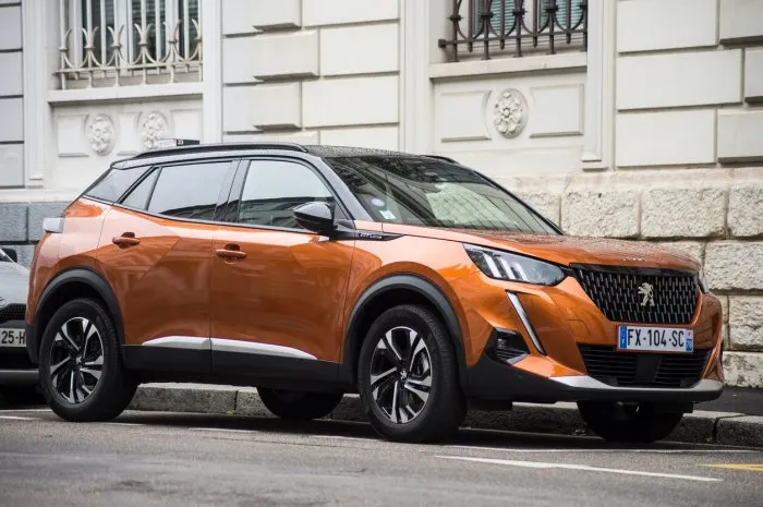 mulhouse - france - 22 august 2021 - front view of orange peugeot 2008 parked in the street