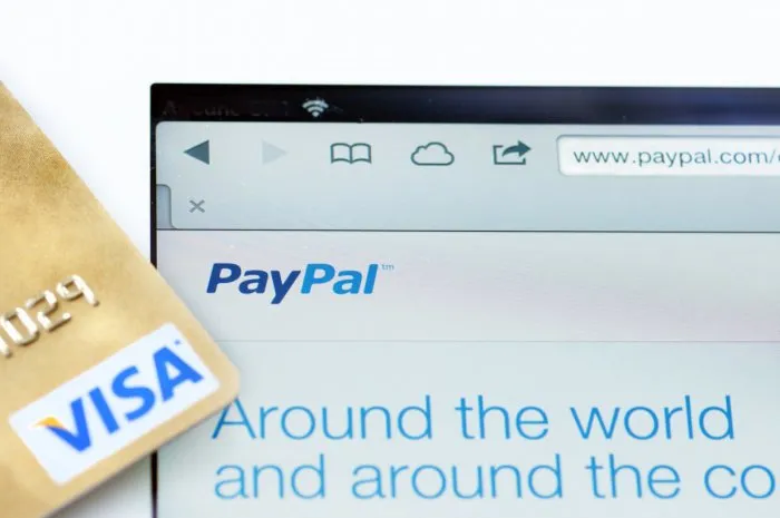 quebec, canada - december 23, 2013  paypal and visa online shoping, using an ipad, money transaction on the internet, or www