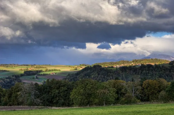 swiss village in fall with approaching rain