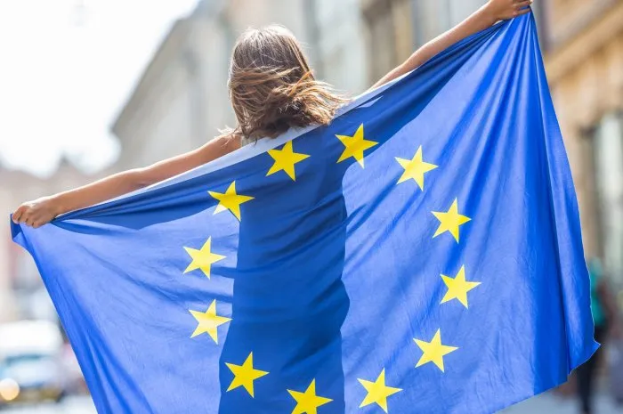 eu flag cute happy girl with the flag of the european union young teenage girl waving with the european union flag in the city