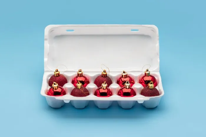 christmas balls, christmas tree decorations, in white egg packaging winter holidays, merry christmas studio shot, close-up, copy space