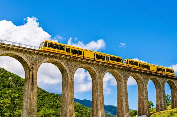 the yellow train (train jaune) on sejourne bridge - france, pyrenees-orientales