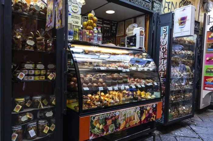 naples, italy - september 10, 2019  display with rum baba or baba au rhum in a candy shop in the old town of naples, italy