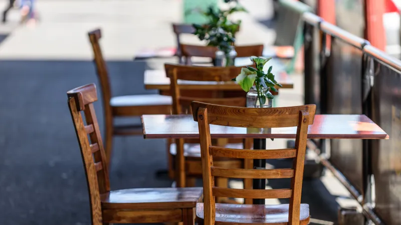 empty table and chairs at a street cafe in melbourne, australia