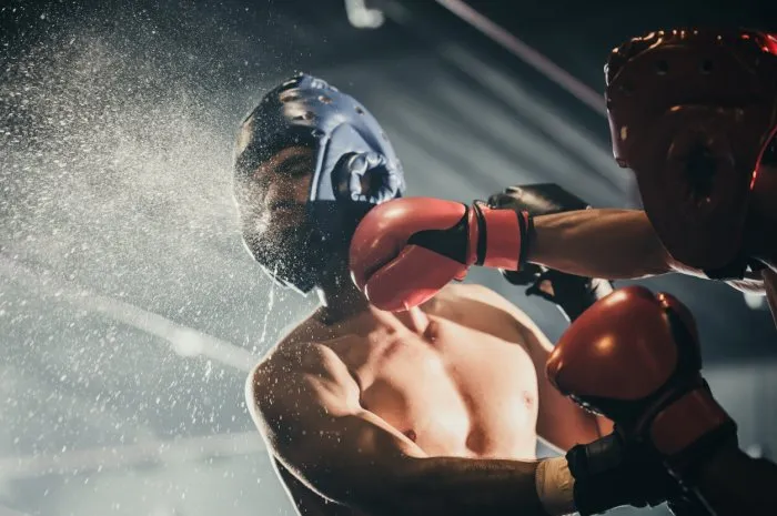 boxer use various punch combinations, including the jab, hook, uppercut, cross, swing, straight getting in close to make opponent on ropes and knockout boxing champions win the round in boxing ring