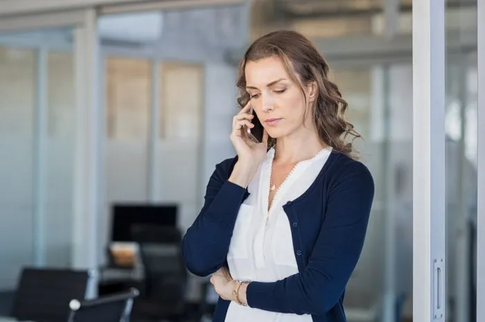 serious business woman looking worried while talking on the phone in conference room frustrated businesswoman in office using mobile phone unhappy mature woman talking on phone call on smartphone
