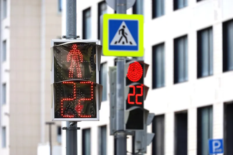 red traffic lights on a city street countdown at the pedestrian crossing