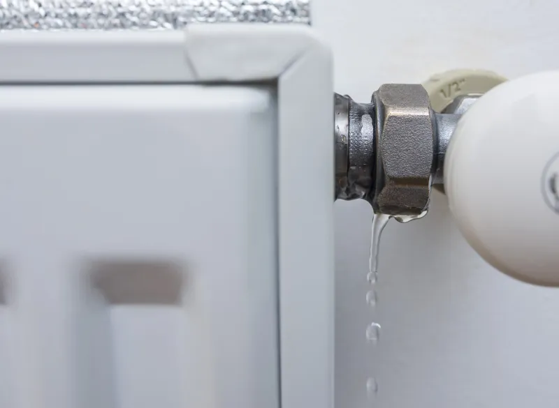 leaking heating radiator defective heater the need for plumbing work in the heating period at home selective focus