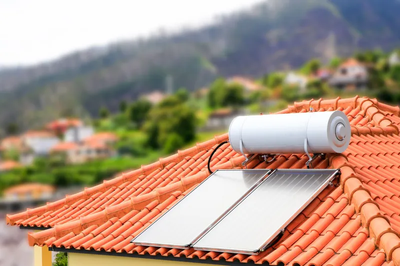 water boiler with solar panels on roof of house