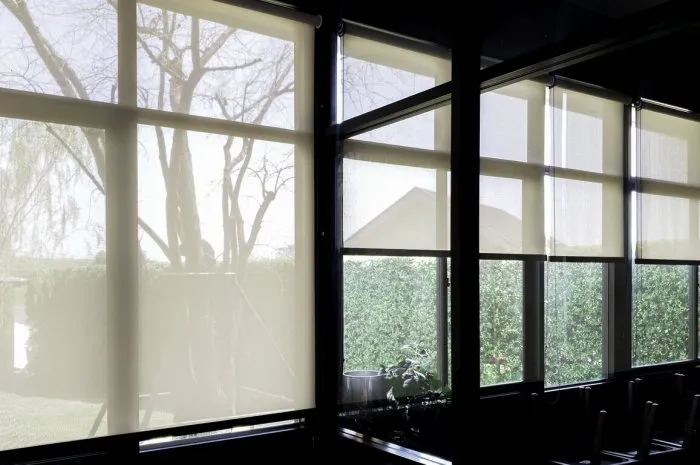 blind on glass window, transparent mirror window frame with curtain to protect sun light, flare light through the window in the morning