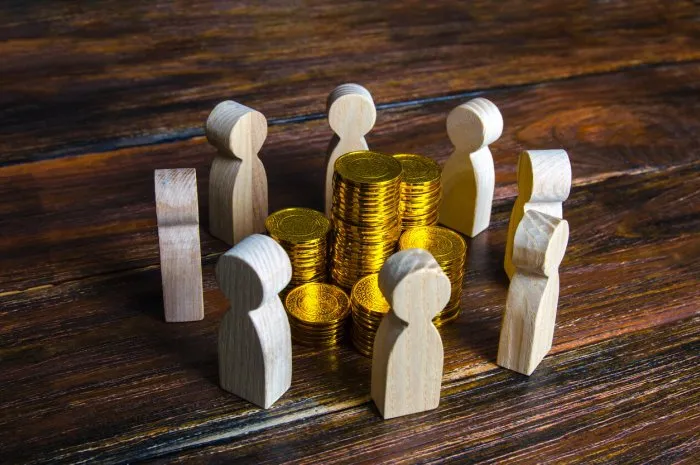 people surrounded stacks of coins fundraising and charity corporation, joint venture fair distribution of income among team members development use of budget funds investment groups corruption