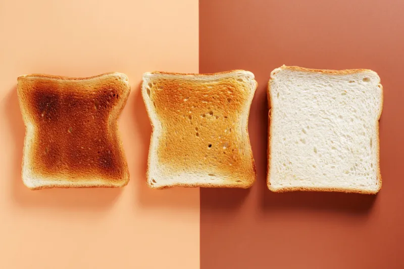 slices of toasted bread, fresh and roasted on two-color background, top view