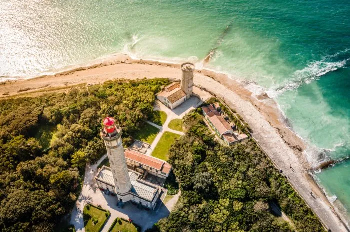 aerial drone shot of the phare des baleines or lighthouse of the whales at sunset and sea view on ile de ré or island of re in france