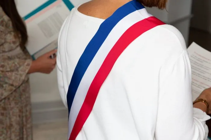 french woman mayor with scarf france flag tricolor during official celebration in city hall