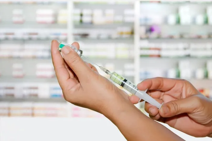 hands the doctors filling a syringe on store medicine and pharmacy drugstore for background