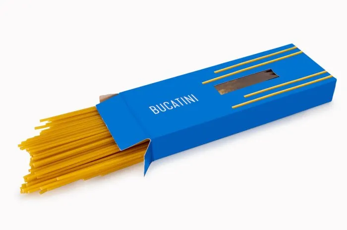 bucatini pasta in blue cardboard box, big perforated spaghetti coming out of the box isolated on white, clipping path