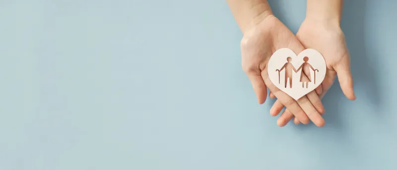 hands holding elderly couple with walking sticks in heart shape, older people mental health, age care concept