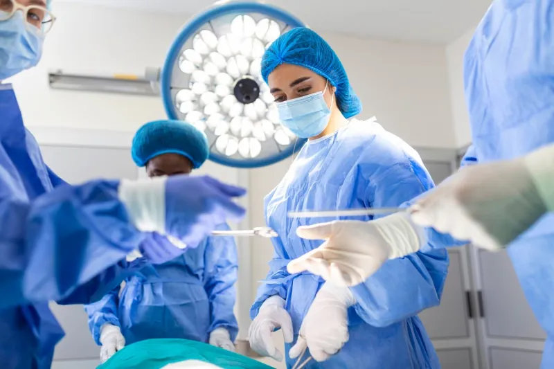 shot in the operating room, assistant hands out instruments to surgeons during operation surgeons perform operation professional medical doctors performing surgery