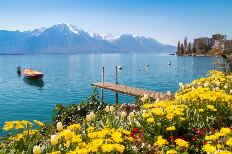 flowers, mountains and jetty on lake geneva, montreux, switzerland