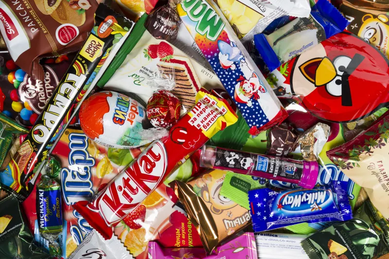 moscow, russia - january 02, 2016  kinder surprise, angry birds, lindor, kit kat, milky way, tempo, mambo, brasilica, pancake, michaszki and many other candies, chocolates and sweets for kids manufactured by different companies studio shot