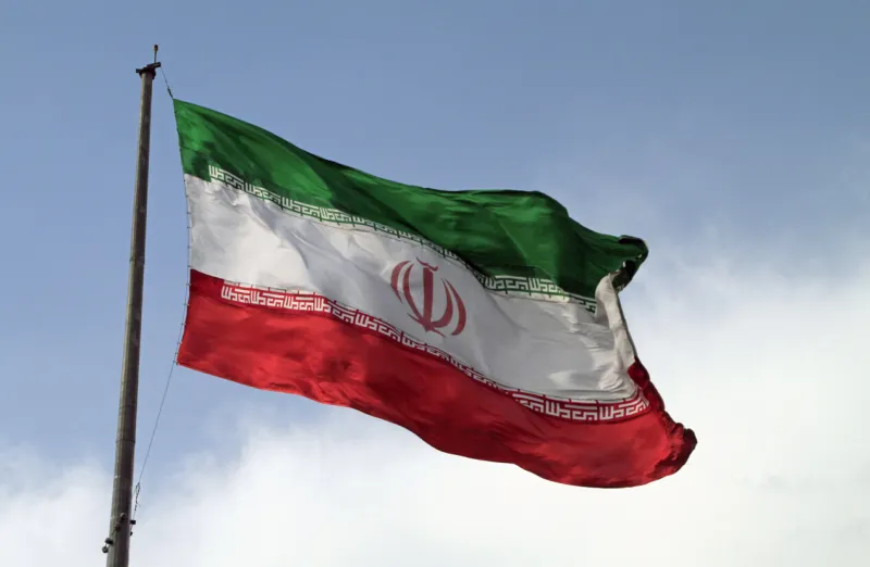 a big flag of iran waving in the wind in tehran, iran