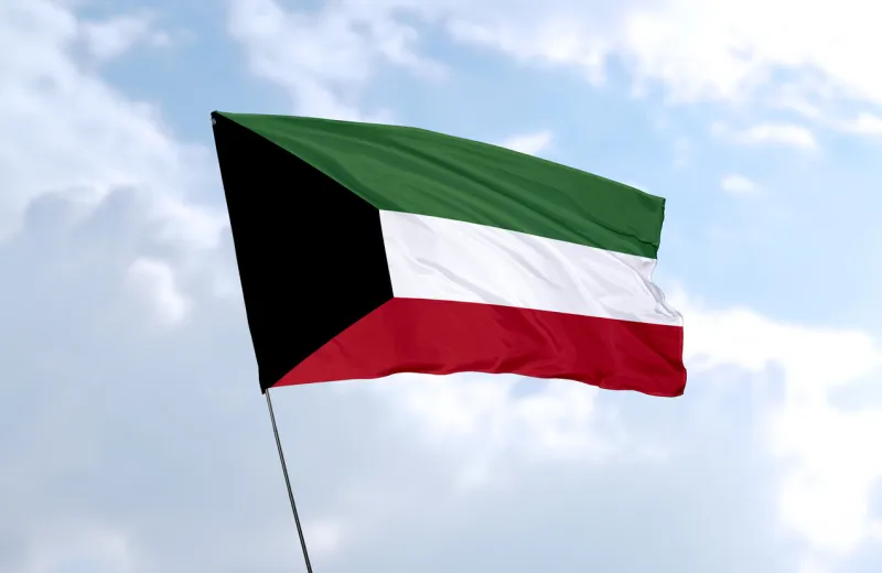 flag of kuwait in front of the blue sky