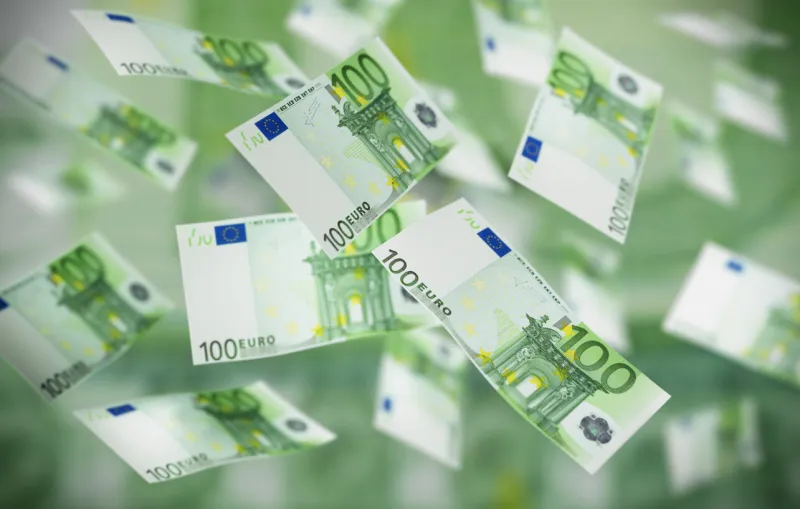 large number of flying 100 euro banknotes in the air