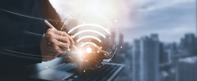 business people hand using laptops or smartphones with wifi icons in the city background, communication and social networks, social network business communication, internet world with new technology