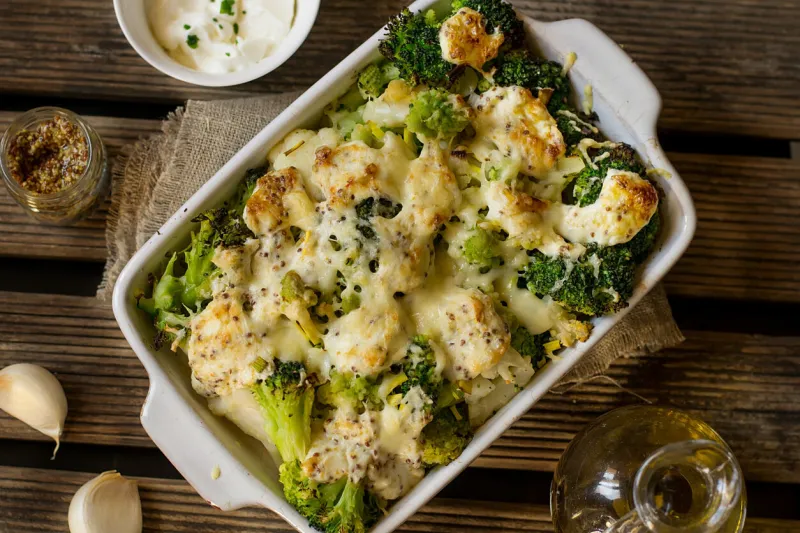 healthy baked gratin of cauliflower, broccoli and romanesco with cream and mustard sauce