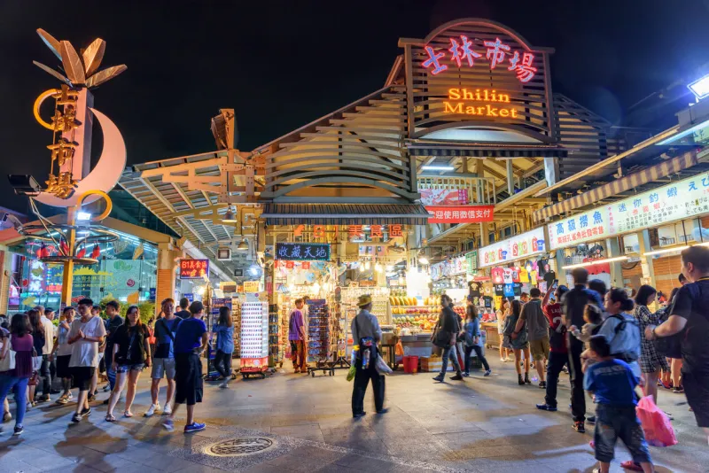 taipei, taiwan - april 26, 2019  evening view of tourists walking along shilin night market the night market is a popular tourist destination and famous shopping area of asia
