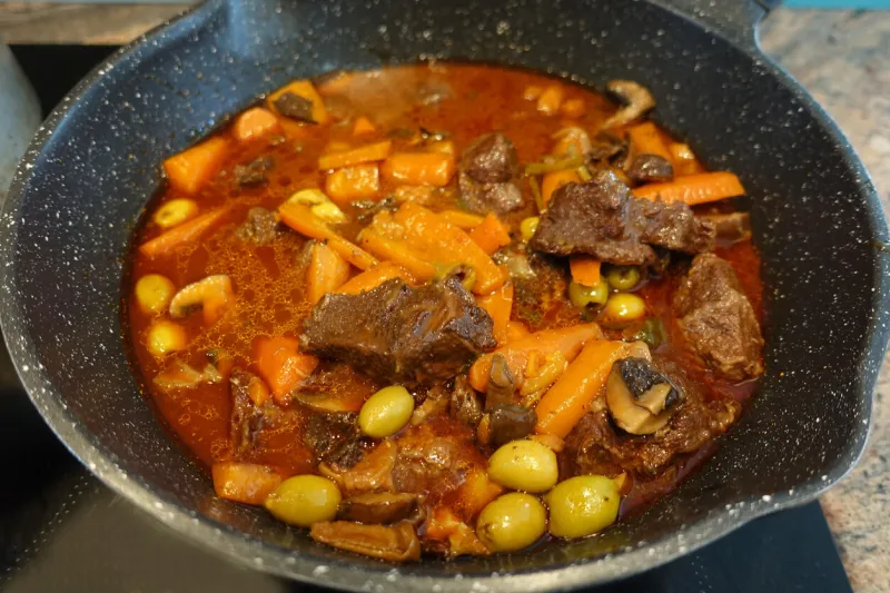 provencal stew bourguignon with beef red wine ang green olives being cooked f rench cuisine
