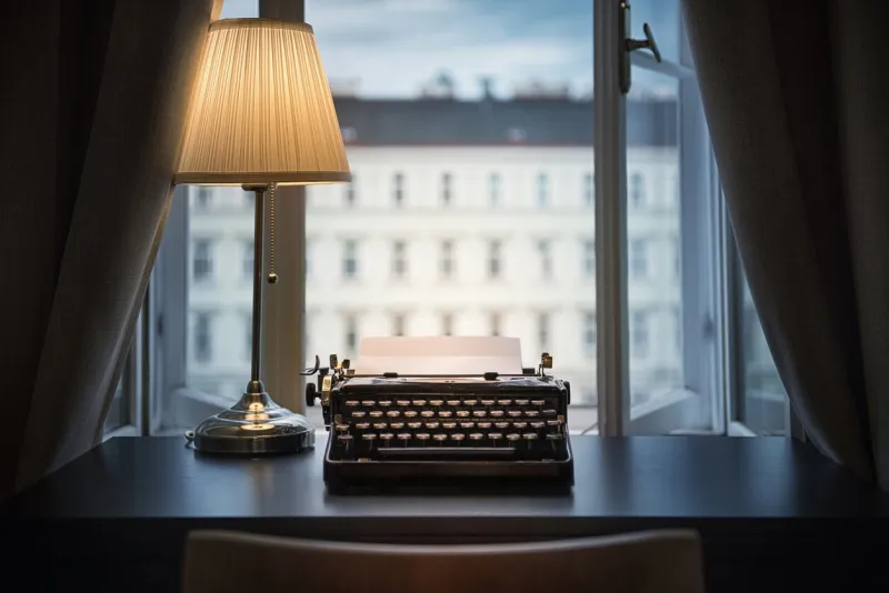 workplace of a writer, journalist, creator an old typewriter and a lamp on the table retro style the concept on scientific, historical, literature, education and philosophical topics