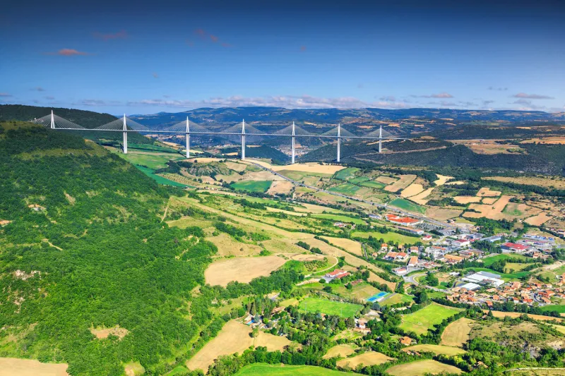 best locations of world, fabulous viaduct of millau in the far distance with agriculture fields, aveyron region, france, europe