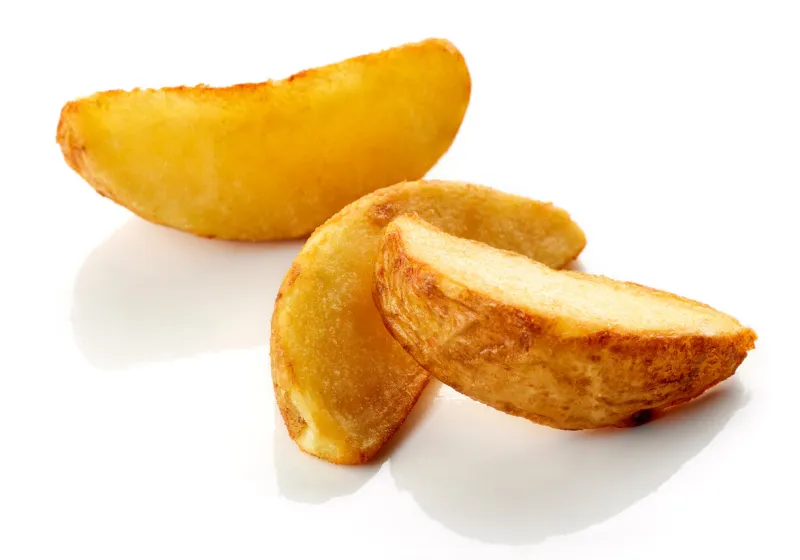 freshly cooked potato wedges isolated on white background
