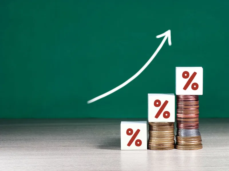 increasing coin stacking with up arrow and percentage sign for increase financial interest rate and business investment growth from dividend concept
