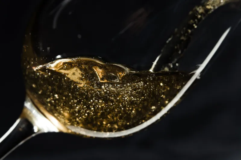 white wine being poured into a wineglass