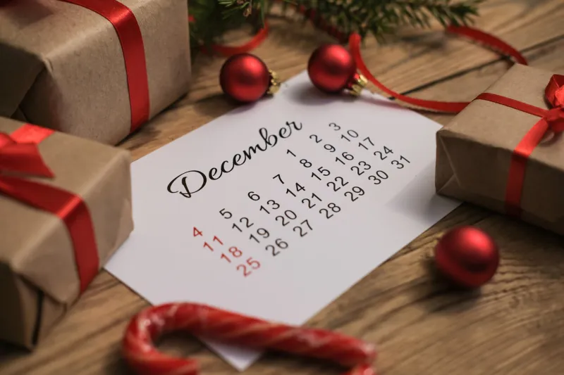 gift boxes and december calendar on wooden table boxing day concept