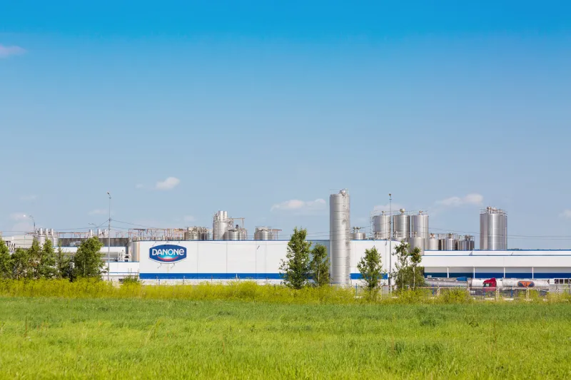 moscow region, russia - august, 2017  danone factory in russia with green grass and blue sky