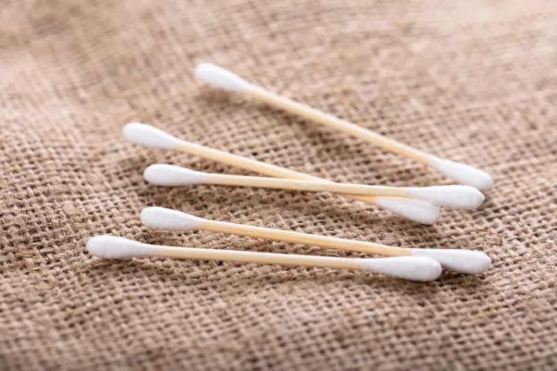 close-up of wooden cotton buds over the sack cloth